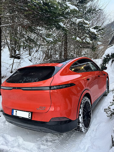 Xpeng G6P fiery orange snowy hill